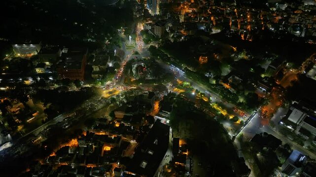 Aerial night view residential complexes, houses and buildings in Bengaluru, Karnataka, A busy junction of three roads in metropolitan city of Bangalore, busy night traffic