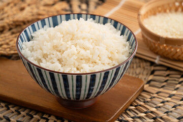 A cookd steamed white rice in a Traditional bowl.