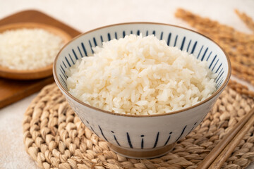 A cookd steamed white rice in a Traditional bowl.