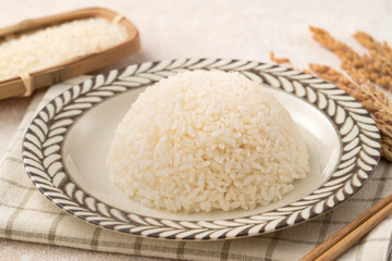 A cookd steamed white rice in a Traditional bowl.