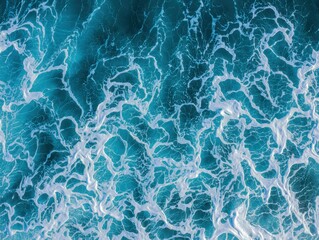 Fototapeta premium Marine abstract background with deep blue summer ocean waves. Water surface showing dynamic splashes and movement patterns.