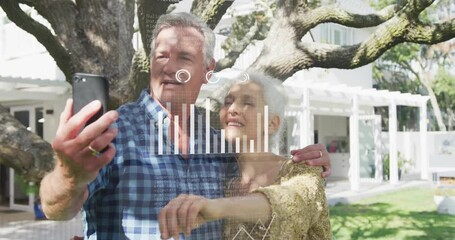 Elderly couple taking selfie with data analytics animation overlay outdoors - Powered by Adobe
