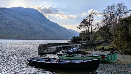Obraz premium Lakeside landscape scenery, old wooden fishing boats at Doo lough, Delphi valley, county Mayo, Ireland, nature and mountains background