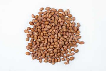 Raw brown peanuts close-up view from above on white background