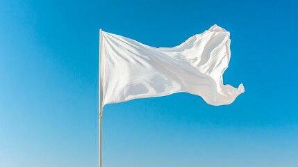 White flag waving against a clear blue sky