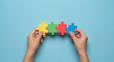 puzzle pieces connected on blue background. Autism awareness concept with colorful elements. Neurodiversity and inclusion. Support services, educational programs, healthcare initiatives.