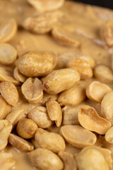 bread with bran and soft peanut butter, peanut butter on a piece of bread and peanuts