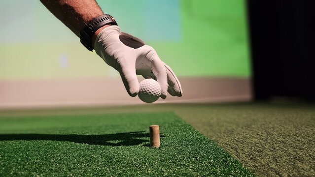 Golf enthusiast prepares to tee off in indoor simulator setting urban sports