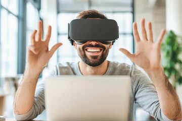Excited Man Wearing VR Headset Gesturing with Hands, Laptop in Front, Experiencing Virtual Reality