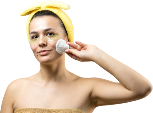 Young beautiful girl in a white towel on his head wears collagen gel patches under her eyes. Mask under eyes treatment face.