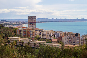 View of Golem and Beach from the Mountain, Albania. A breathtaking view of Golem, a coastal town in Albania, along with its beach and the vast sea, seen from the mountain. 