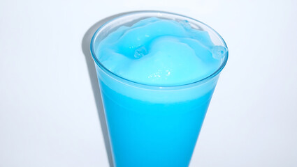 Refreshing blue slush drink served in a clear cup. 