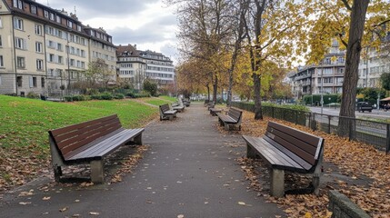 A scenic autumn pathway in a Zurich park, lined with golden trees and wooden benches.
