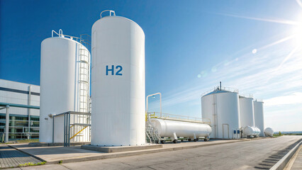 Obraz premium A hydrogen storage tank with blue and white colours, placed on a grass field against a white background. Concept of clean energy in 3D Rendering 