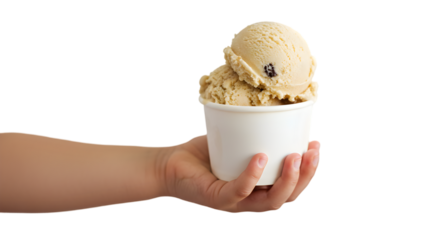 Child's hand holding a white paper cup filled with two scoops of light brown ice cream on black background