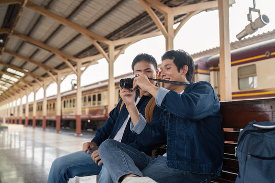 Travel and Friendship. Two friends capturing memories at the train station, sharing excitement for their journey.