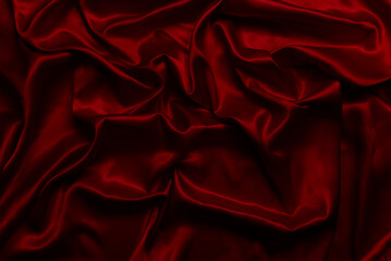 The top view of the red satin surface looks luxurious and beautiful. with sparkling waves Abstract background design copy space Card or banner (blurred or blurry)