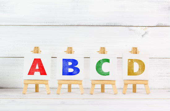 Colorful Alphabet Letters ABCD Displayed on Wooden Easels for Learning and Education