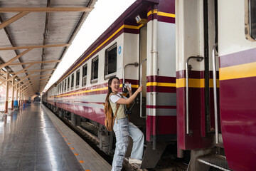 Travel Enthusiast and Energetic Boarding. A young woman steps onto the train, eager to start her...