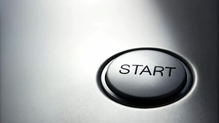 Hand poised to push start button, close up of metal technology symbolizing initiation of control and new journey.