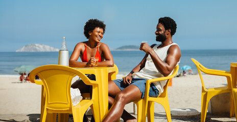 Couple enjoying a sunny beach day in Rio de Janeiro