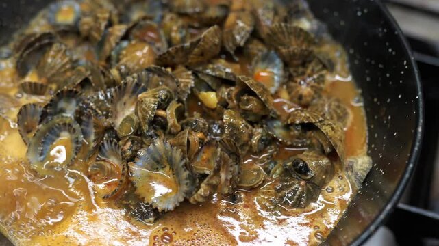 Northern spain and canary islands traditional limpets dish, cooking in a pan