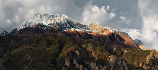 Panoramic view of snow mountains and forests of Annapurna III Massif in Himalayas, where trekking route passes in Annapurna Conservation Area, Nepal