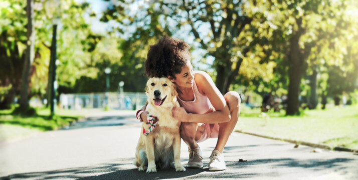 Woman, walk and dog in park, hug and break for fitness with care, smile or outdoor in summer with loyalty. Person, animal or pet labrador on path for rest, bonding and training for wellness in Brazil
