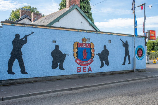 Ballyclare, Northern Ireland - August 27th, 2022 - Ulster Defence Association (UDA) loyalist paramilitary mural on wall with red hand of Ulster motif, South East Antrim 