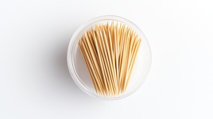 Toothpicks in clear container on white background