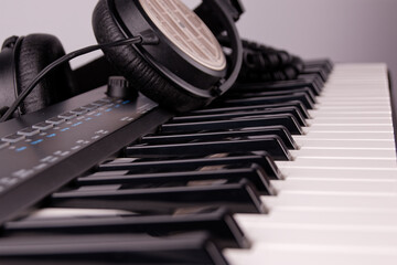 View of a music keyboard with a set of keys and headphones