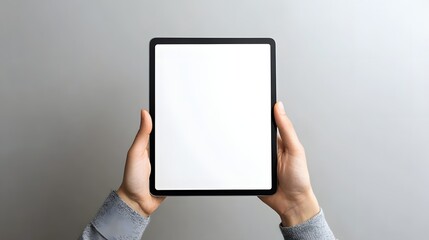 someone holding a tablet with a white screen in their hands