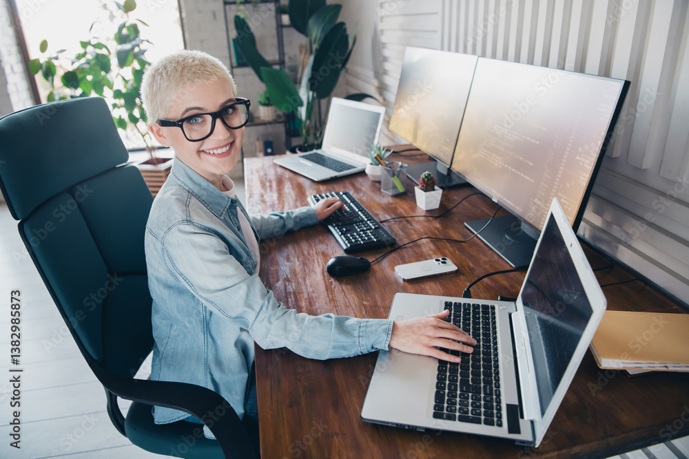 Poster modern programmer woman working with multiple screens at home office in casual style