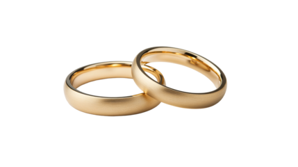 Pair of gold wedding bands close up on black background, cut out transparent