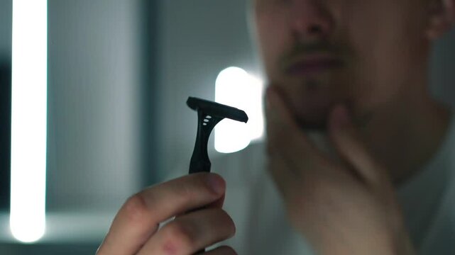Shaving kit.
Close-up of a disposable facial razor.
Sharp razor in the hands of a bearded European man