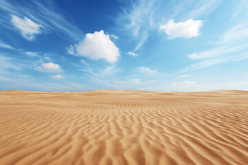 Expansive desert landscape with undulating sand dunes under a bright blue sky