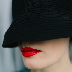 Black hat and lips with red lipstick makeup