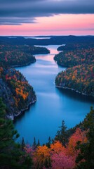 Naklejka premium Serene autumn landscape featuring a winding river surrounded by vibrant foliage under a pastel sunset sky aerial view