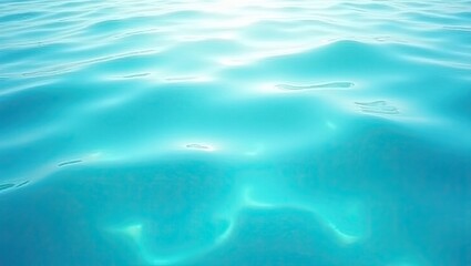 Obraz premium Serene turquoise waters reflecting soft sunlight over gentle waves, creating a tranquil and inviting atmosphere.