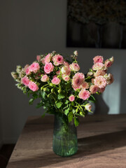 A Stunningly Beautiful Bouquet of Delightful Pink Roses Displayed in an Elegant Green Vase