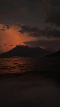Vertical view of a boat ride on Lake Atitlan in Guatemala during sunset