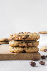 Large chocolate chip cookies on a white countertop, homemade chocolate chip cookies on a white background