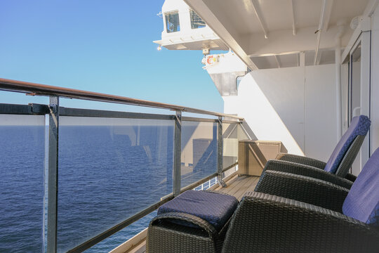 Luxurious ocean view or oceanview or outside balcony veranda cabin stateroom suite queen king double bed on luxury ocean liner cruiseship cruise ship in classic classy interior Art Deco style design