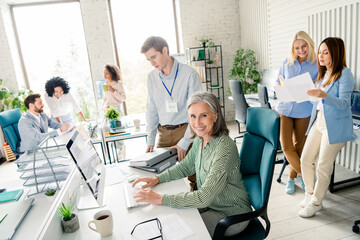 Professionally diverse team collaborating in a modern office environment with friendly atmosphere...