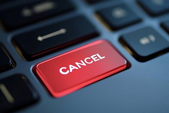 Red glowing cancel key stands out on a sleek, modern keyboard, representing the ability to stop, undo, or terminate a process or subscription