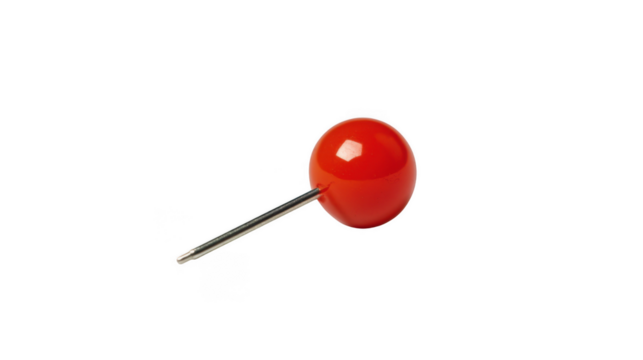A close up shot of a single red push pin with a silver needle on a black isolated background space