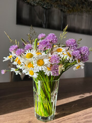 An Elegant Wildflower Bouquet beautifully arranged in a stunning Glass Vase for all occasions