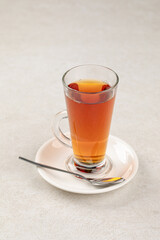 Glass mug of hot black tea