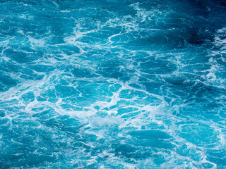 Turbulent, choppy sea between rocks near the coast on the north coast of Madeira. Well suited as a background.