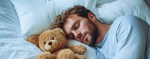 Young man sleeping peacefully with teddy bear in bed